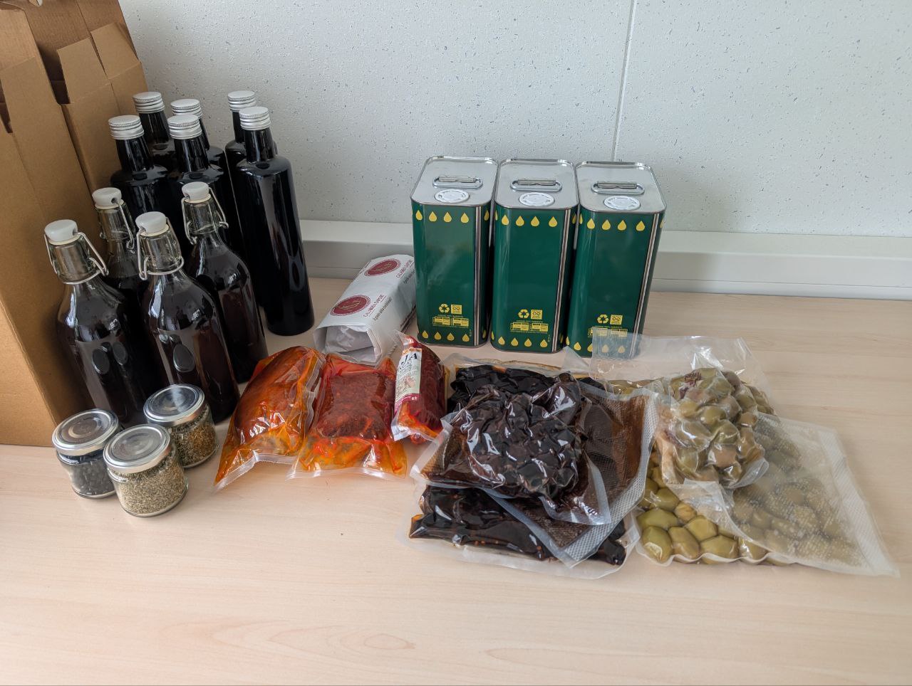 Southern Italy products showcase including olive oil, olives, nduja, and oregano